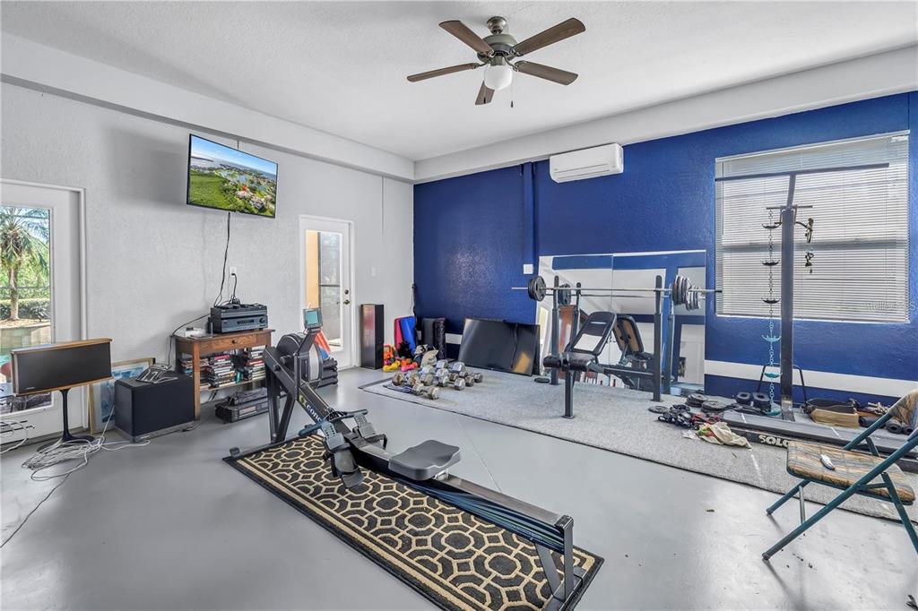 2101 North Pointe Alexis Drive, Unit 1 Tarpon Springs, FL 34689 - Photo 42 of 63 a work room with furniture a rug and white walls