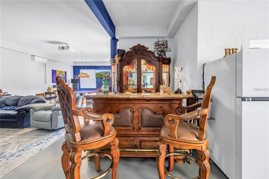 2101 North Pointe Alexis Drive, Unit 1 Tarpon Springs, FL 34689 - Photo 44 of 63 a living room with furniture a flat screen tv and floor to ceiling window