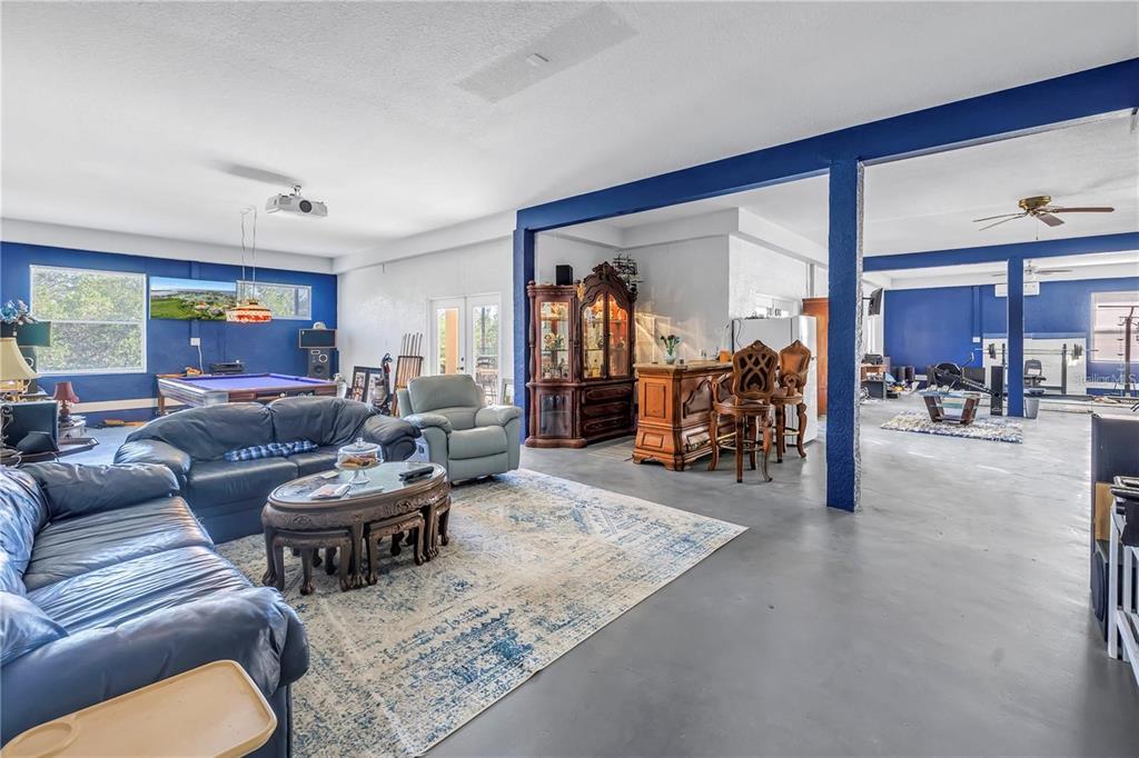 2101 North Pointe Alexis Drive, Unit 1 Tarpon Springs, FL 34689 - Photo 47 of 63 a living room with furniture and a table