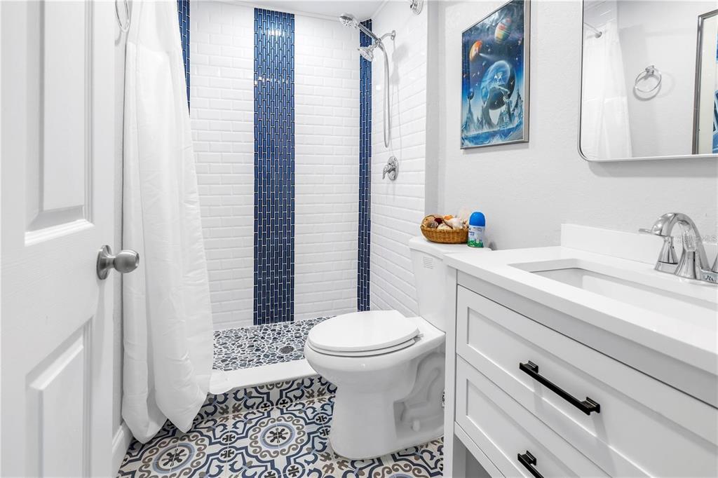 2101 North Pointe Alexis Drive, Unit 1 Tarpon Springs, FL 34689 - Photo 48 of 63 a bathroom with a sink toilet and shower