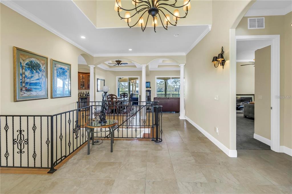2101 North Pointe Alexis Drive, Unit 1 Tarpon Springs, FL 34689 - Photo 5 of 63 a view of a hallway with workspace and windows