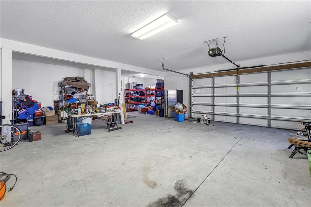 2101 North Pointe Alexis Drive, Unit 1 Tarpon Springs, FL 34689 - Photo 52 of 63 a view of a garage with rack and bicycle