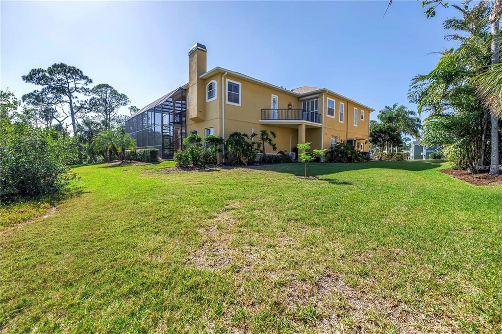 2101 North Pointe Alexis Drive, Unit 1 Tarpon Springs, FL 34689 - Photo 57 of 63 a front view of a house with a yard