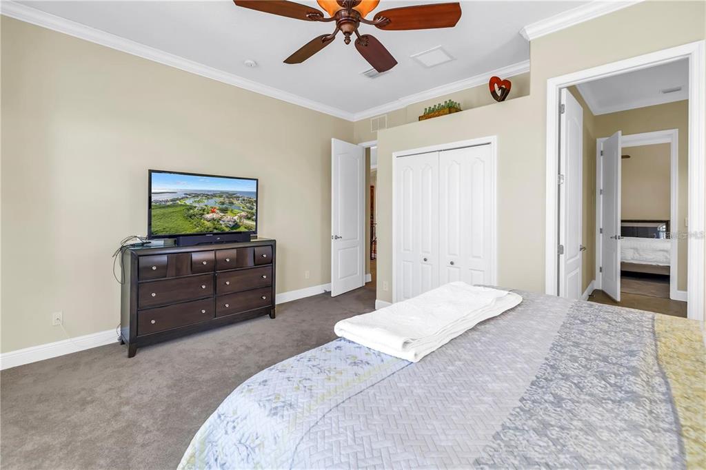 2101 North Pointe Alexis Drive, Unit 1 Tarpon Springs, FL 34689 - Photo 8 of 63 a bedroom with a bed and a flat screen tv