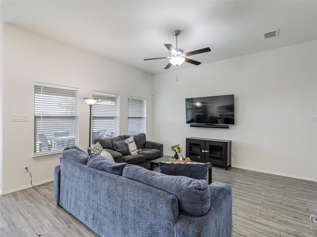 4517 Ashmark Road Aubrey, TX 76227 - Photo 18 of 26 a living room with furniture and a flat screen tv