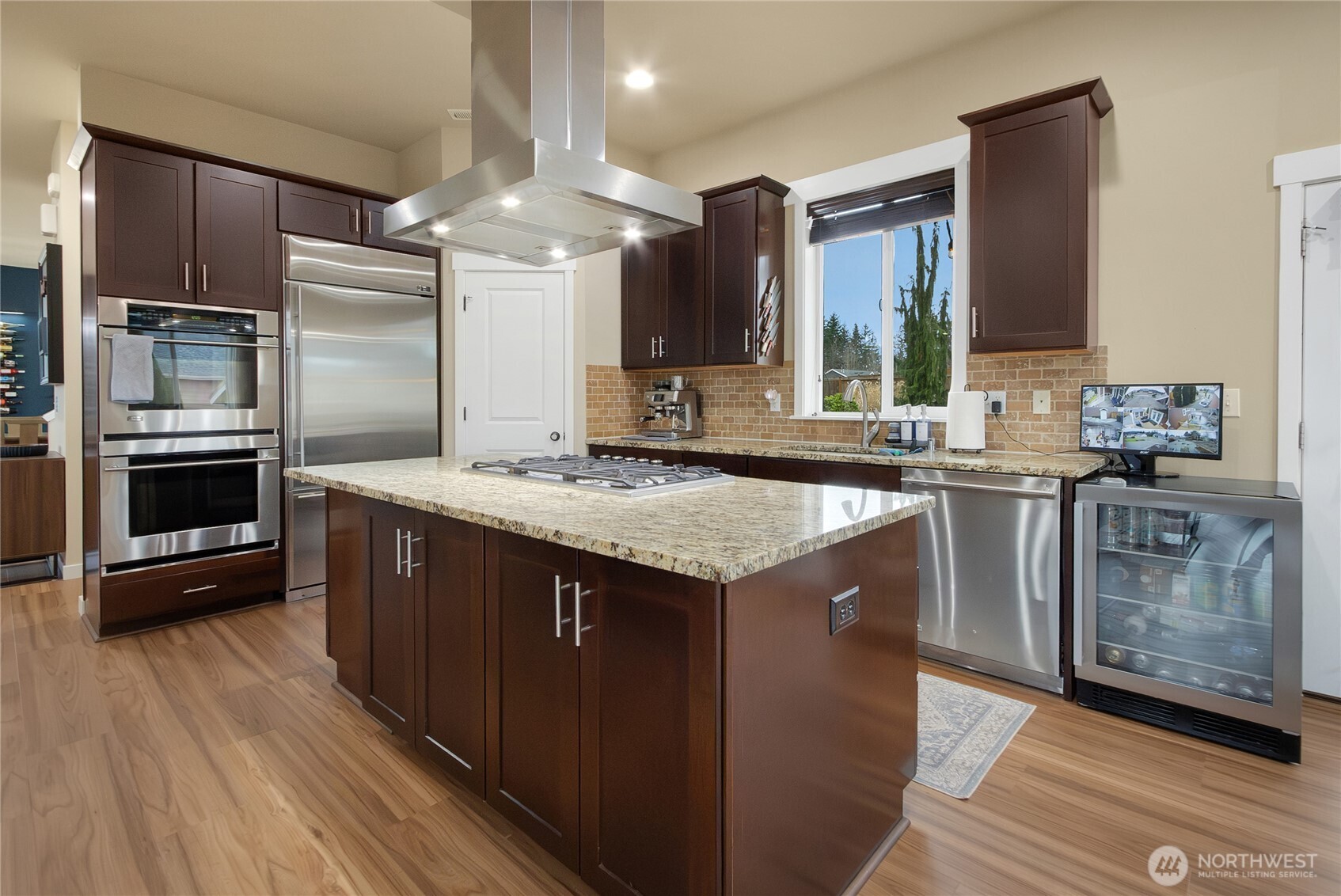 889 Lund Street Buckley, WA 98321 - Photo 8 of 25 a kitchen with stainless steel appliances granite countertop a sink a stove and a refrigerator