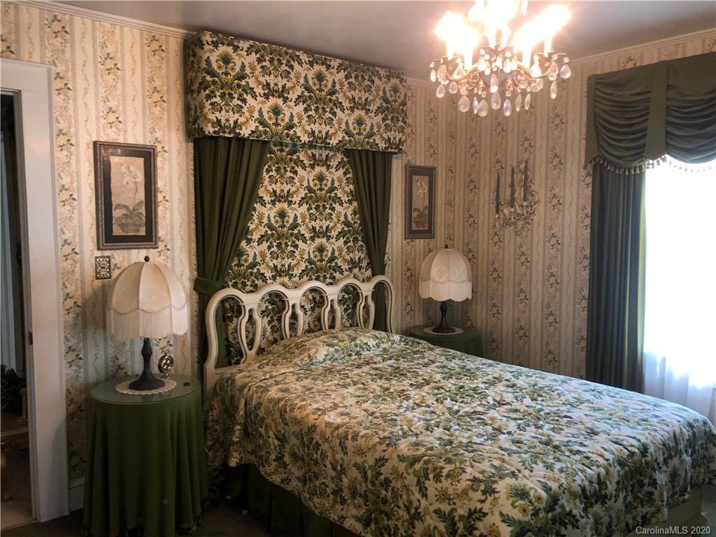 6234 Cress Road Concord, NC 28025 - Photo 22 of 24 a bedroom with a bed and a chandelier