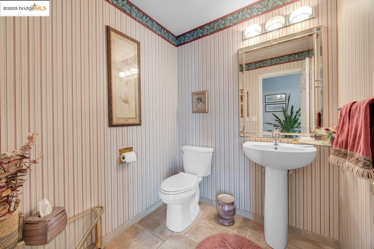 13700 Clements Road Groveland, CA 95321 - Photo 36 of 93 Half bath with toilet and wallpapered walls