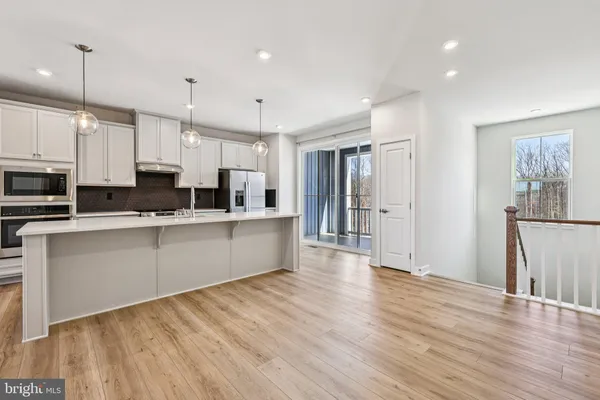a large kitchen with stainless steel appliances lots of counter space