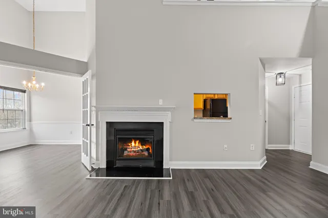 a view of a livingroom with wooden floor and a fireplace