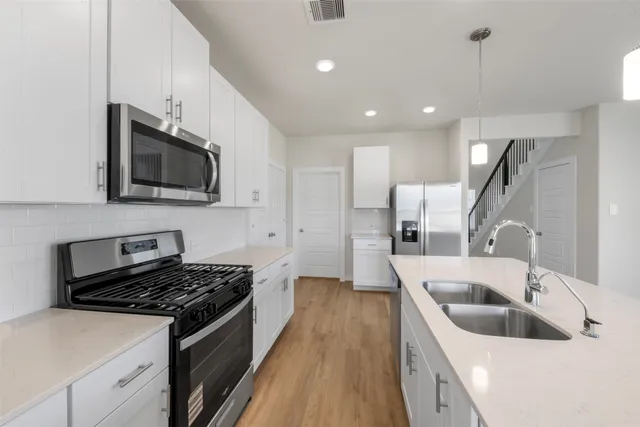 a kitchen that has a sink and a stove