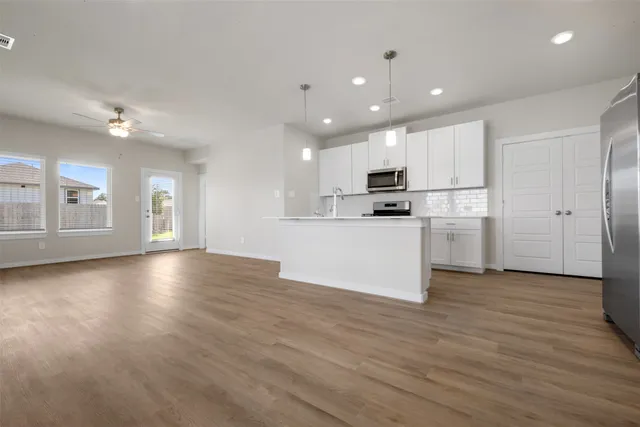 a view of kitchen with cabinets and wooden floor