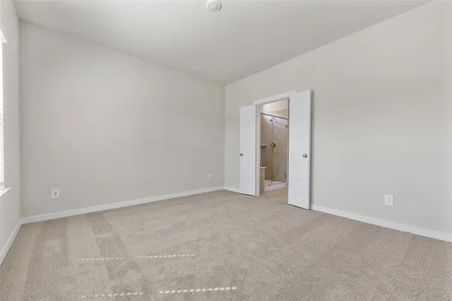 a view of an empty room and closet area