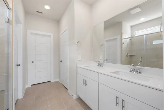 a bathroom with a double vanity sink mirror and