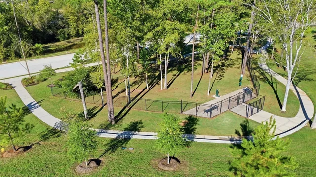 an aerial view of a yard with plants and large trees