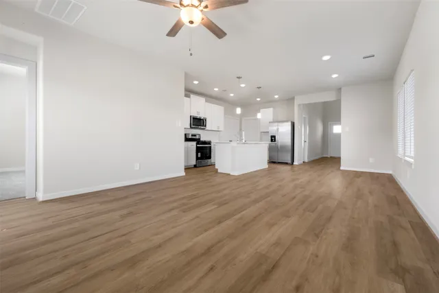 a view of a kitchen with a sink and a refrigerator