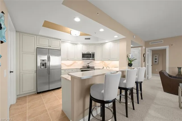 a kitchen with a table chairs sink and cabinets