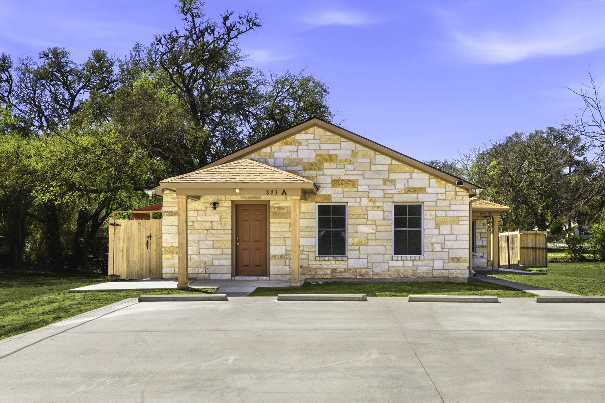 823 North Commerce Street, Unit A Lockhart, TX 78644 - Photo 1 of 28 a front view of a house with a yard and garage
