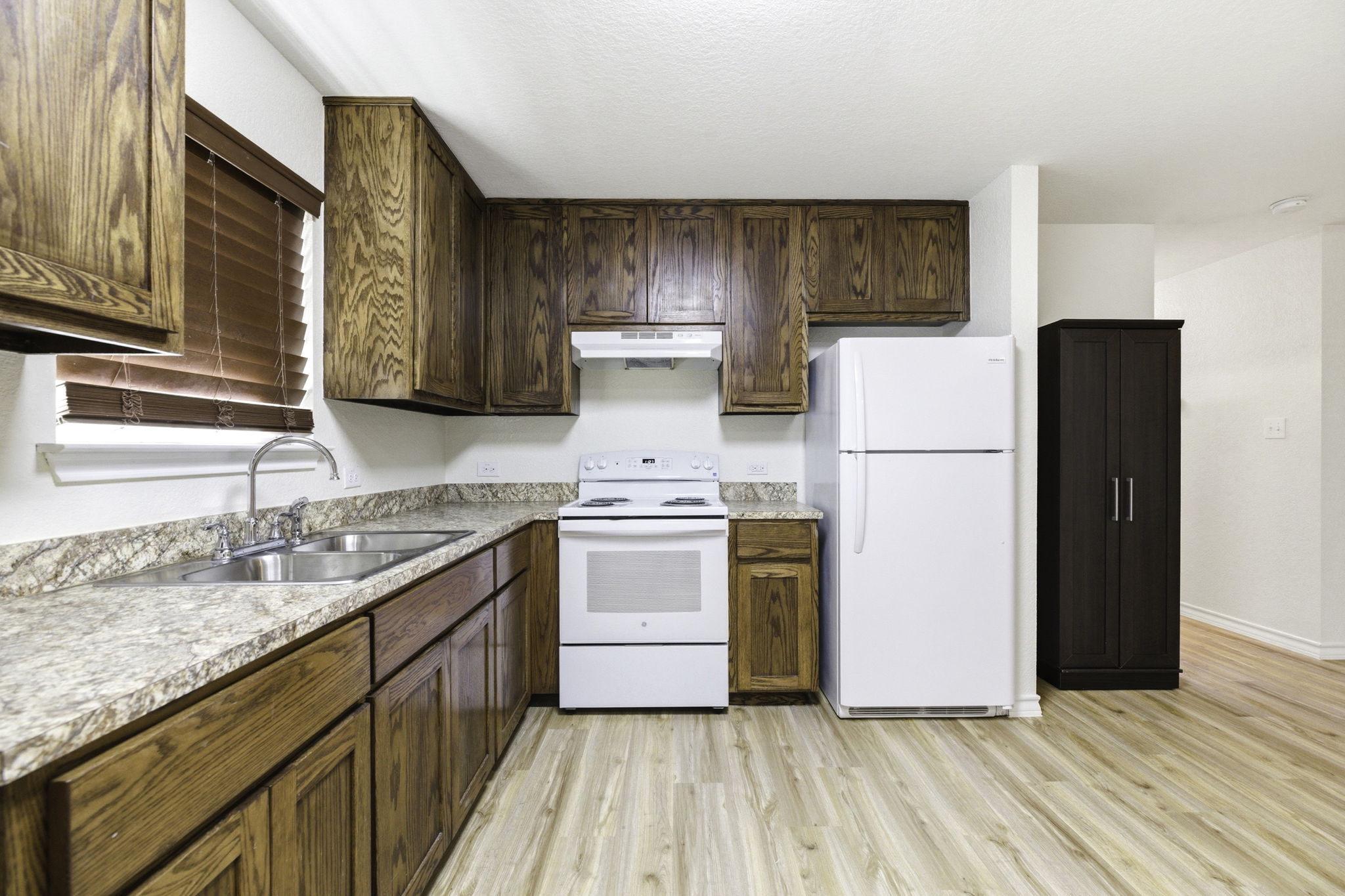 823 North Commerce Street, Unit A Lockhart, TX 78644 - Photo 11 of 28 a kitchen with a refrigerator sink and cabinets