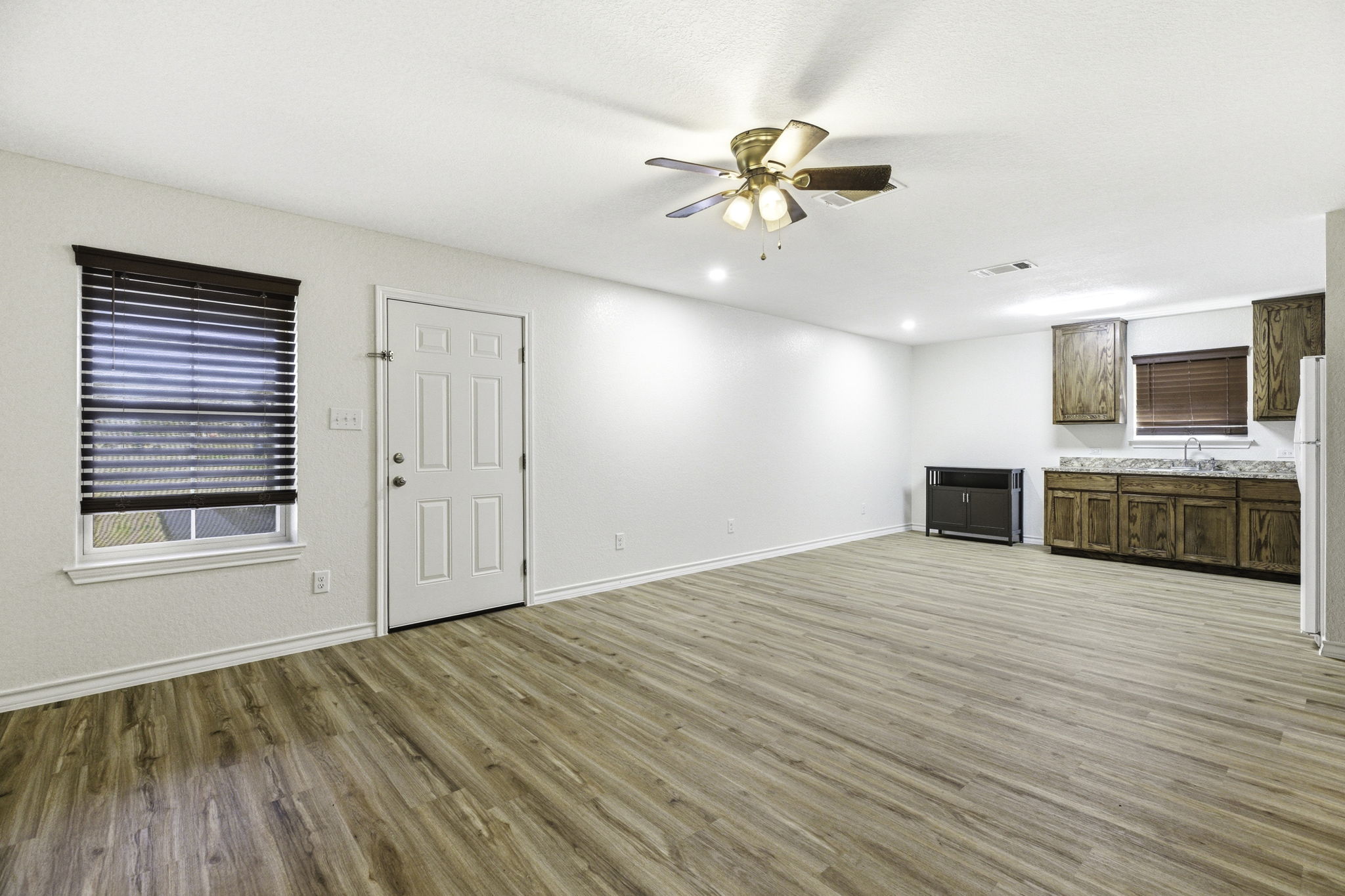 823 North Commerce Street, Unit A Lockhart, TX 78644 - Photo 12 of 28 a view of an empty room with a kitchen and a window