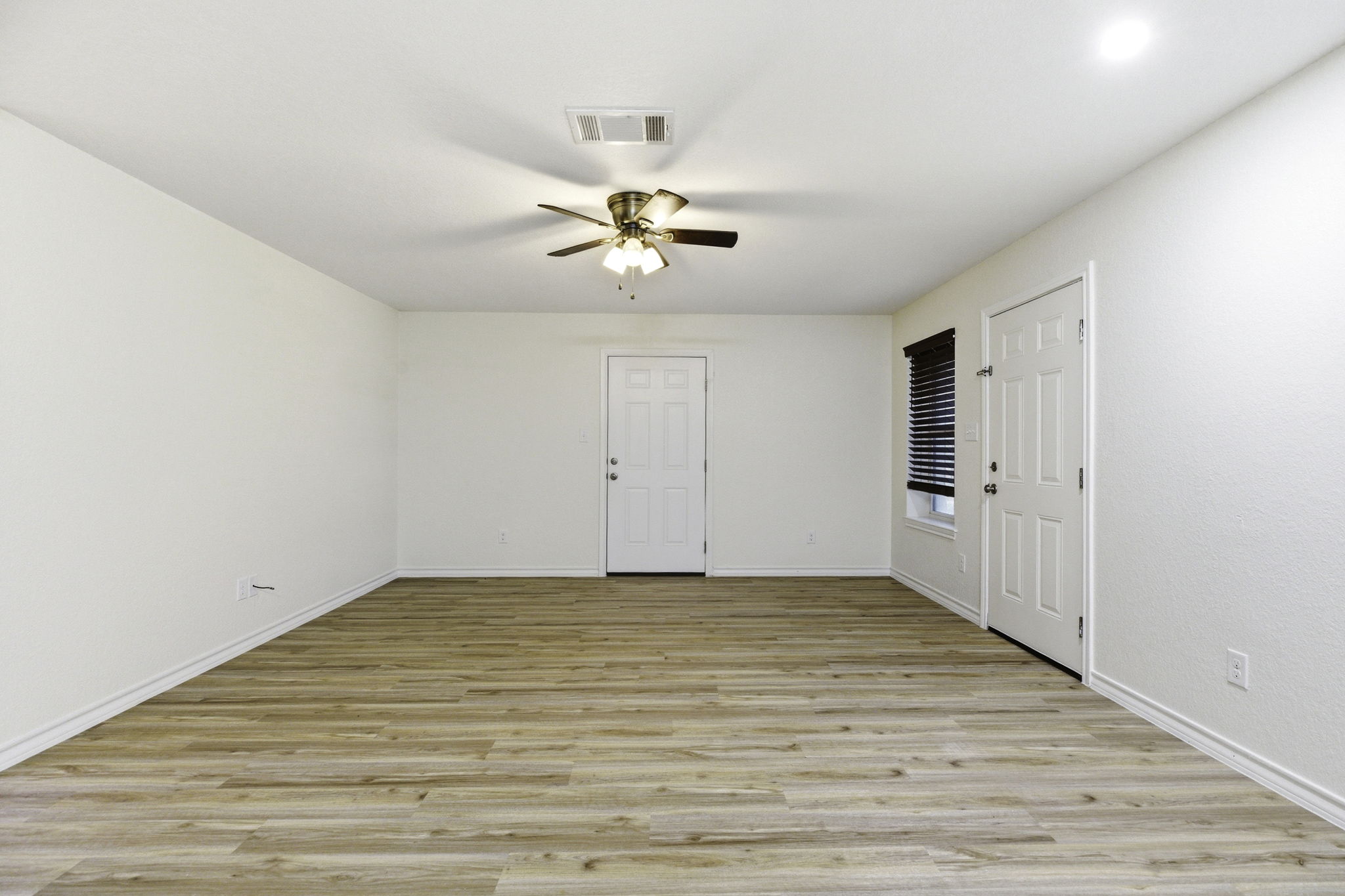 823 North Commerce Street, Unit A Lockhart, TX 78644 - Photo 14 of 28 wooden floor in an empty room