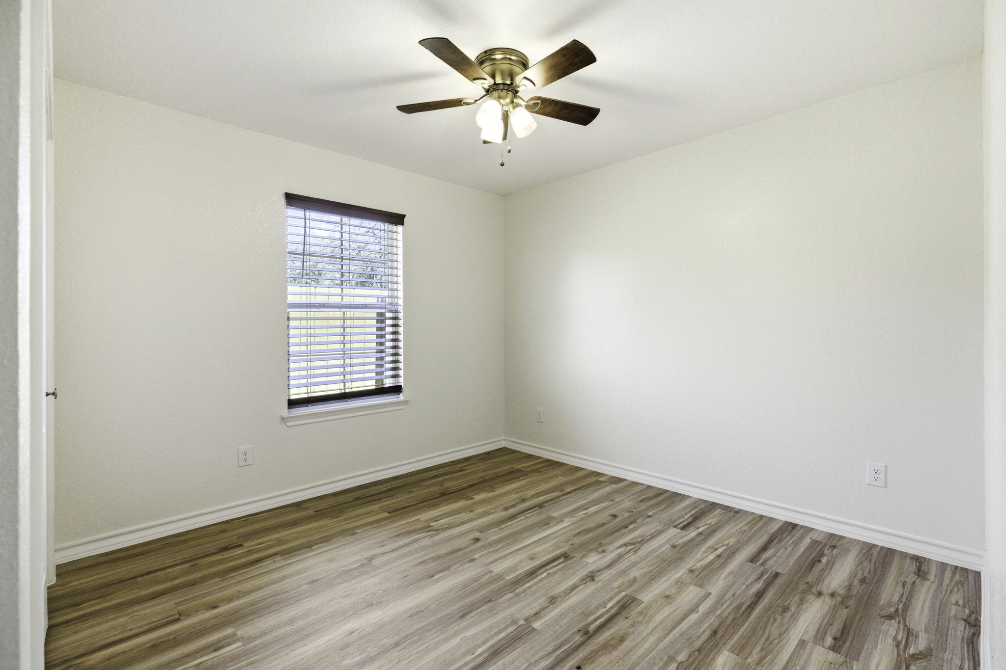 823 North Commerce Street, Unit A Lockhart, TX 78644 - Photo 16 of 28 an empty room with a window and a ceiling fan