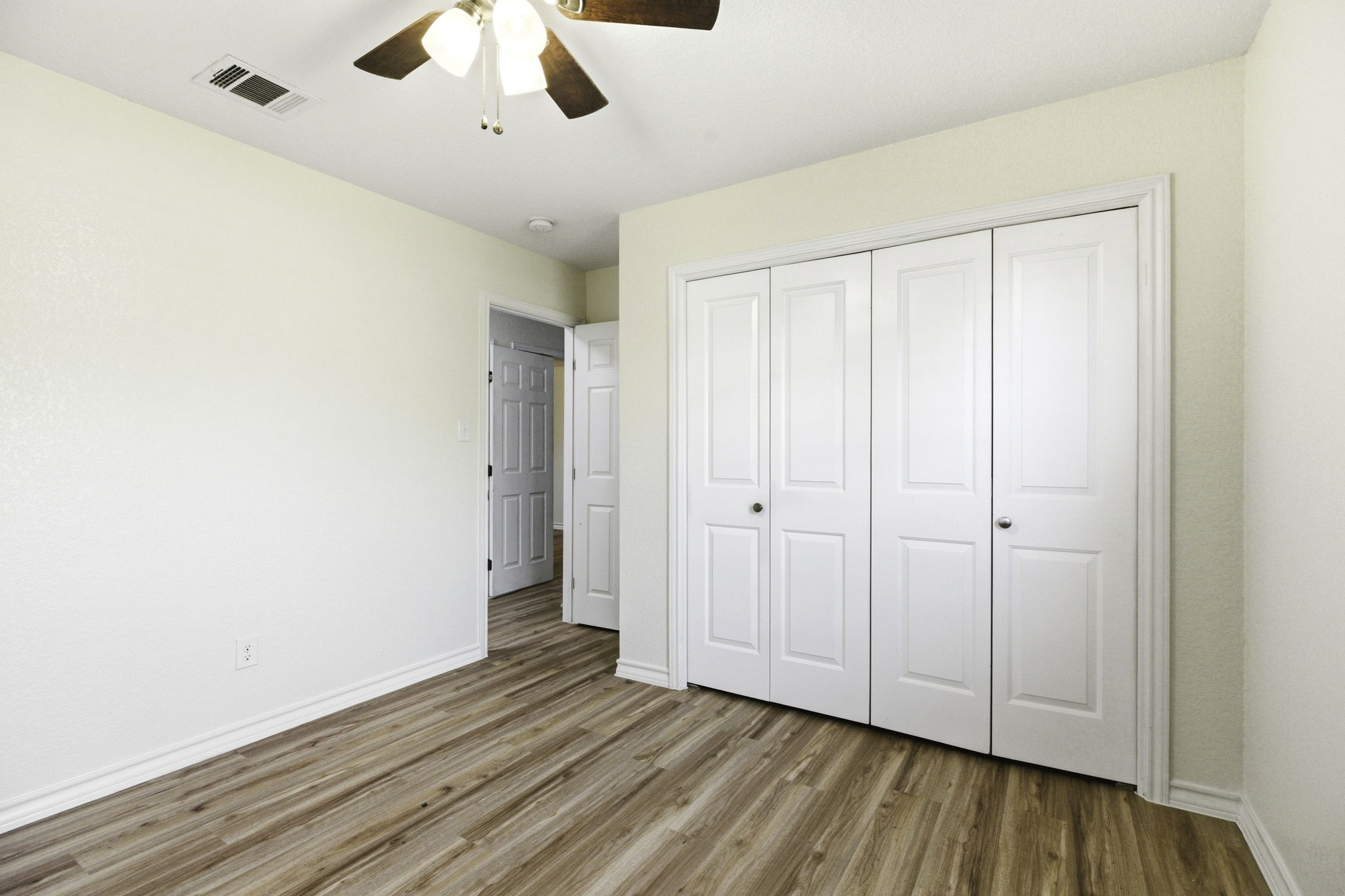 823 North Commerce Street, Unit A Lockhart, TX 78644 - Photo 17 of 28 a view of an empty room with wooden floor