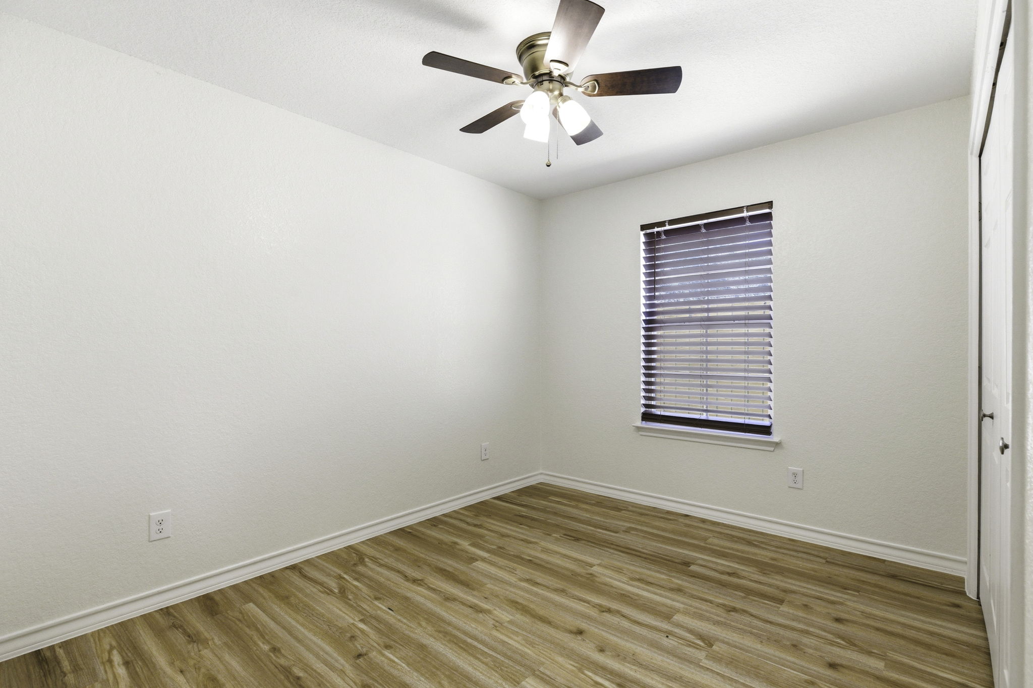 823 North Commerce Street, Unit A Lockhart, TX 78644 - Photo 22 of 28 an empty room with a window and a fan