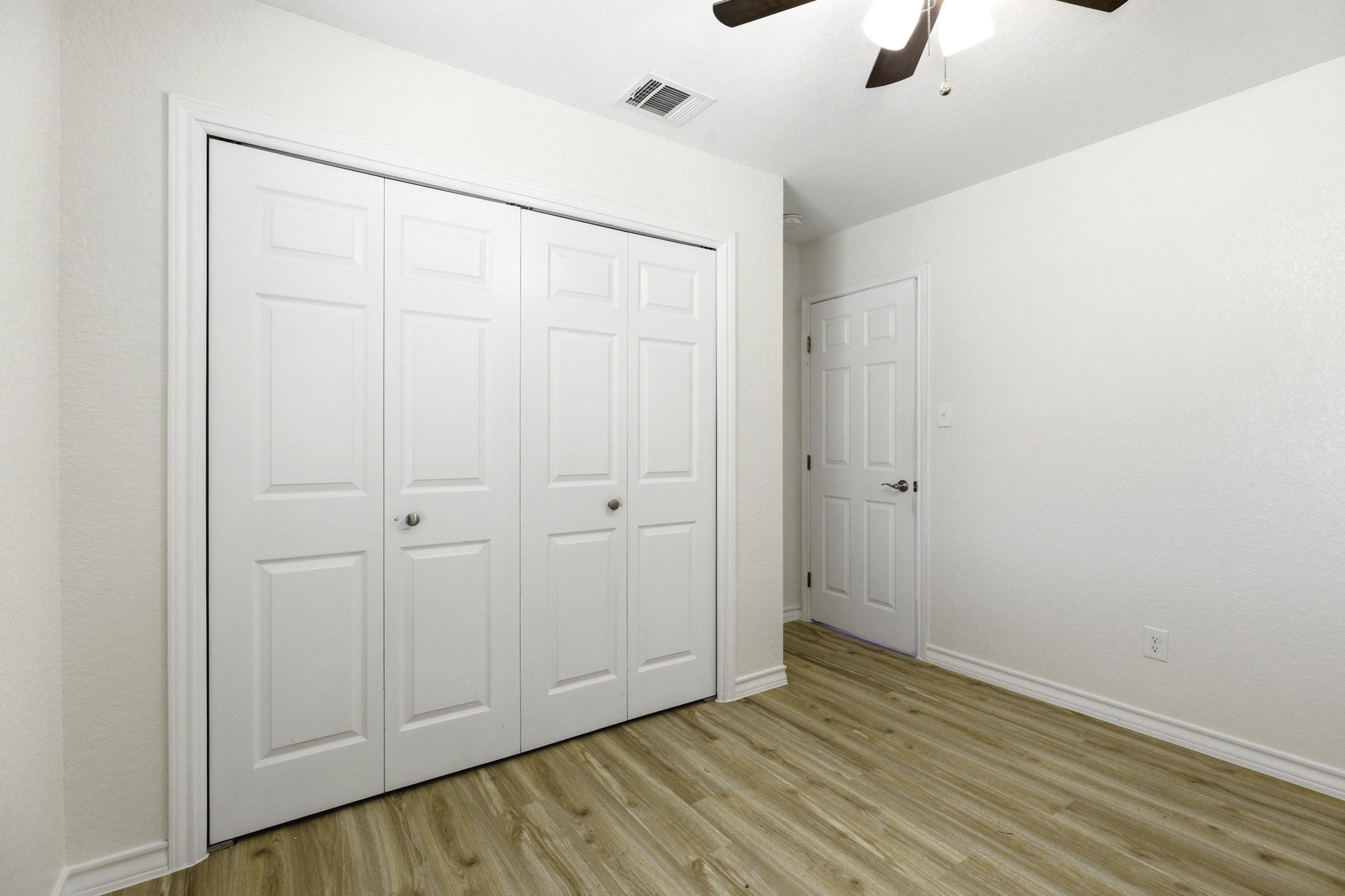 823 North Commerce Street, Unit A Lockhart, TX 78644 - Photo 23 of 28 a view of an empty room with wooden floor