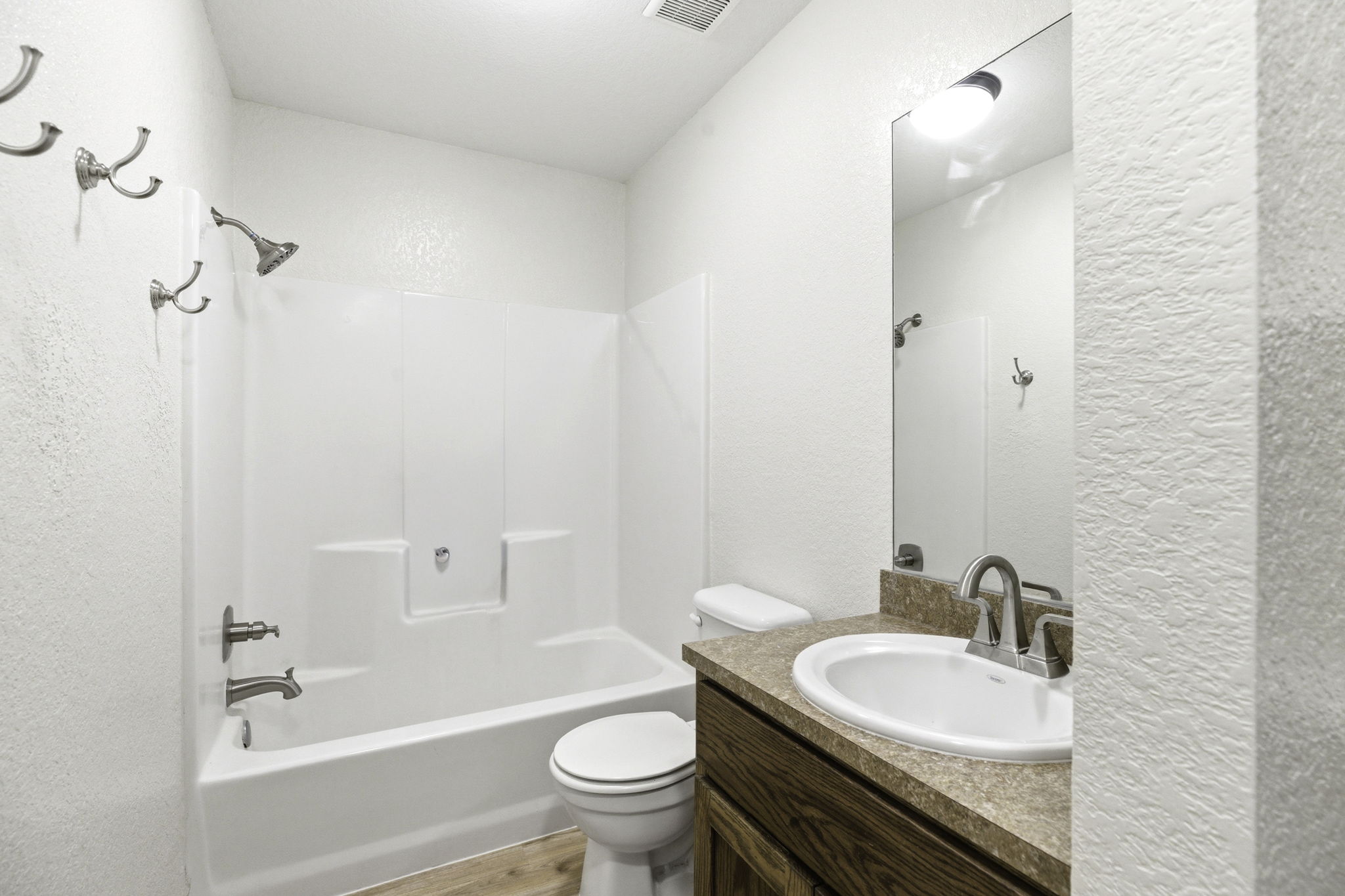 823 North Commerce Street, Unit A Lockhart, TX 78644 - Photo 24 of 28 a bathroom with a sink a toilet and a bathtub
