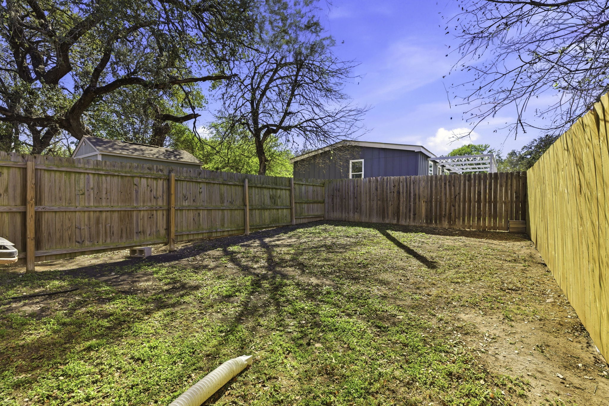 823 North Commerce Street, Unit A Lockhart, TX 78644 - Photo 27 of 28 a view of a backyard with wooden fence