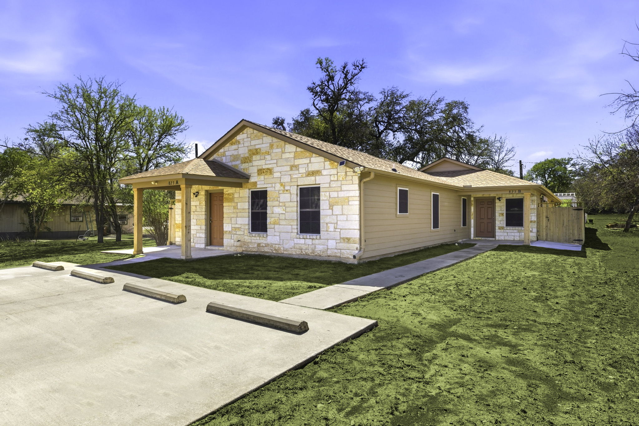 823 North Commerce Street, Unit A Lockhart, TX 78644 - Photo 4 of 28 a view of a yard in front of a house with large trees