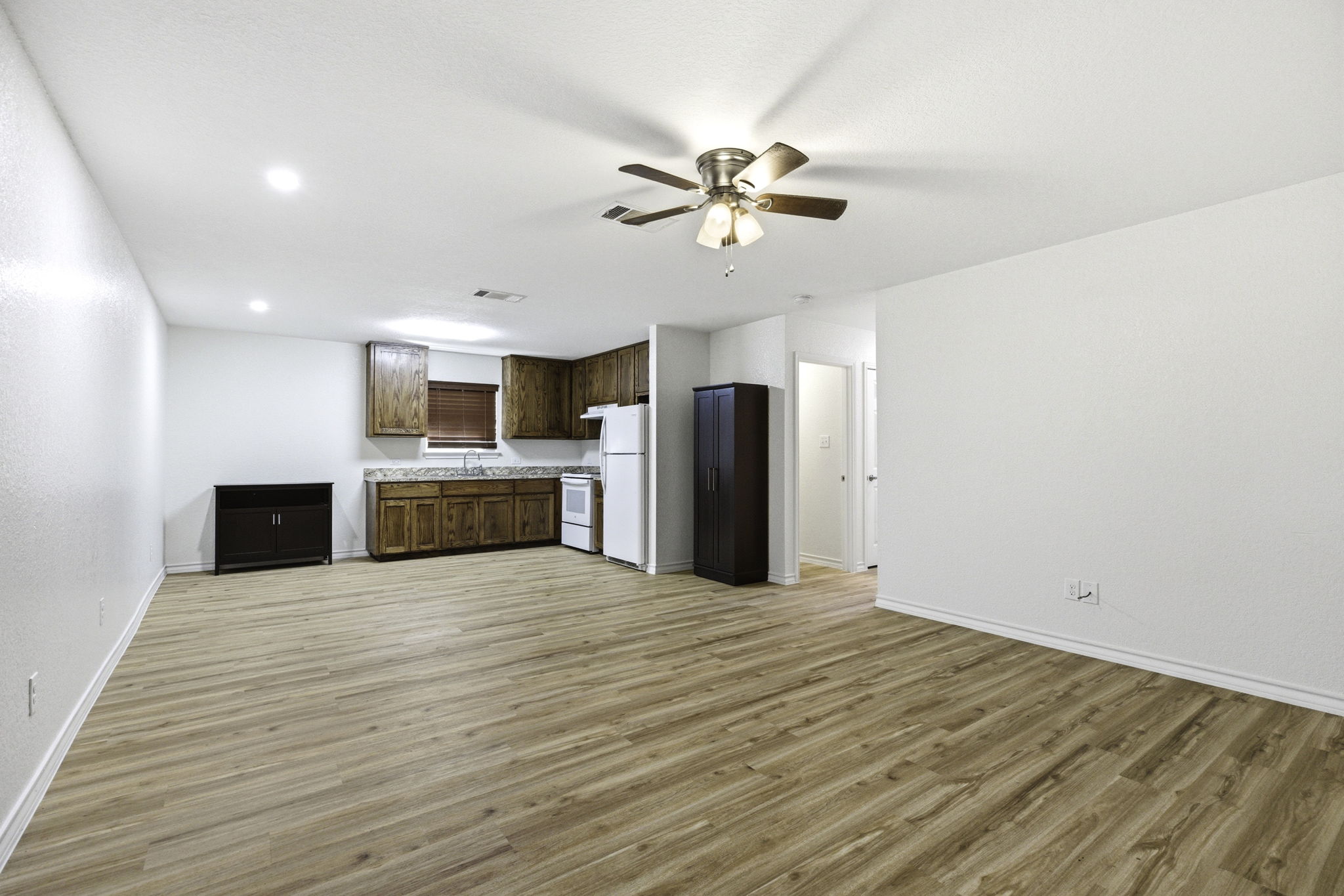 823 North Commerce Street, Unit A Lockhart, TX 78644 - Photo 7 of 28 a view of a kitchen with a stove cabinets and wooden floor