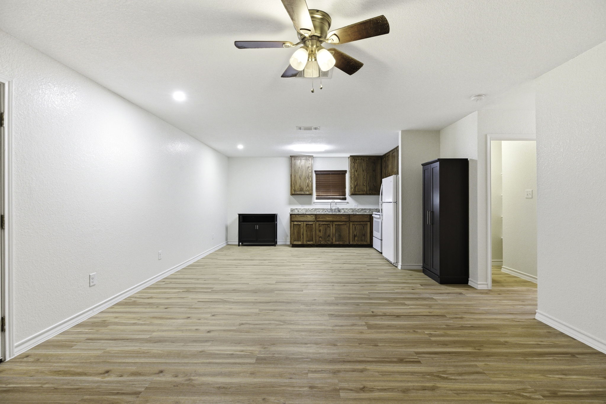 823 North Commerce Street, Unit A Lockhart, TX 78644 - Photo 8 of 28 a view of an empty room with kitchen and a window