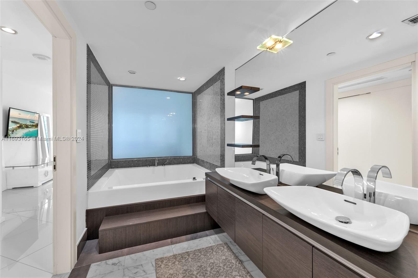 Downtown Miami Miami, FL 33131 - Photo 12 of 25 a bathroom with a double vanity sink and a bathtub