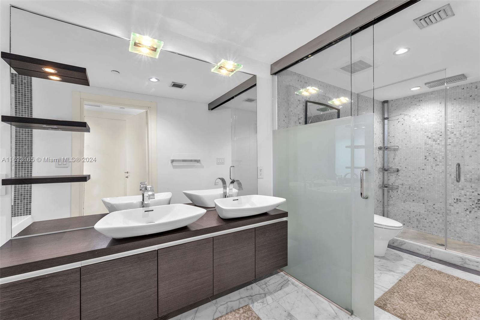 Downtown Miami Miami, FL 33131 - Photo 13 of 25 a bathroom with a sink shower and a mirror