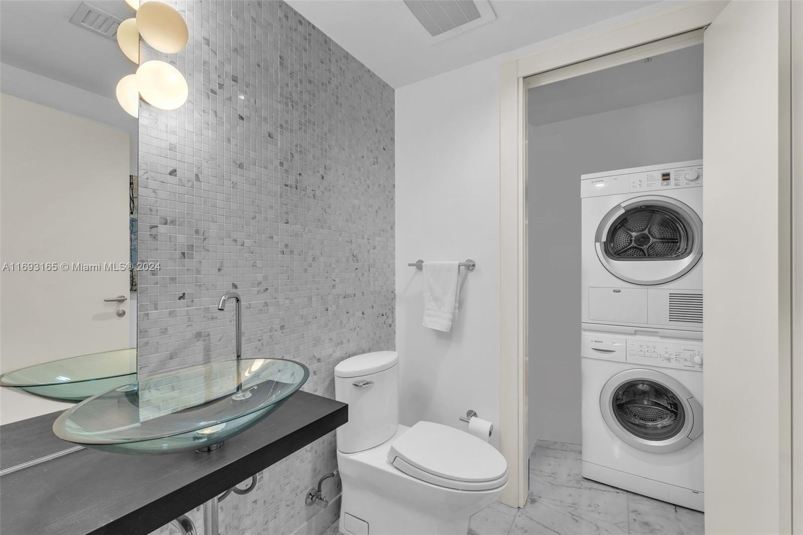 Downtown Miami Miami, FL 33131 - Photo 15 of 25 a white toilet sitting next to a bathroom sink