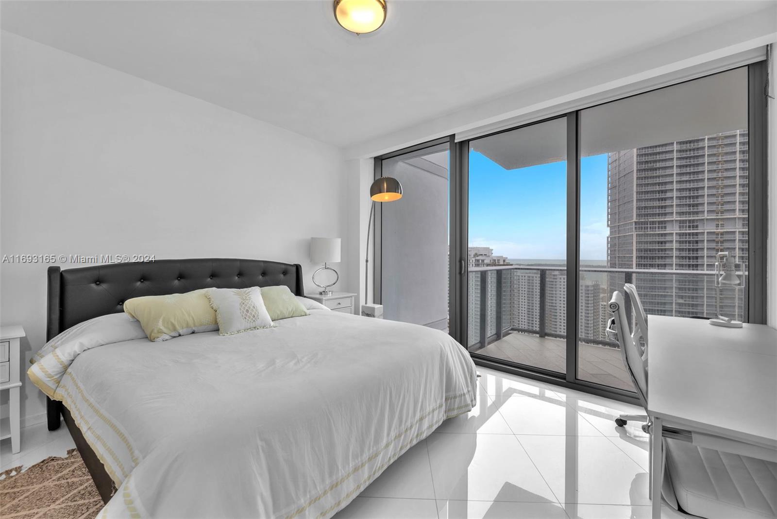 Downtown Miami Miami, FL 33131 - Photo 17 of 25 a bedroom with a bed and painting on the wall