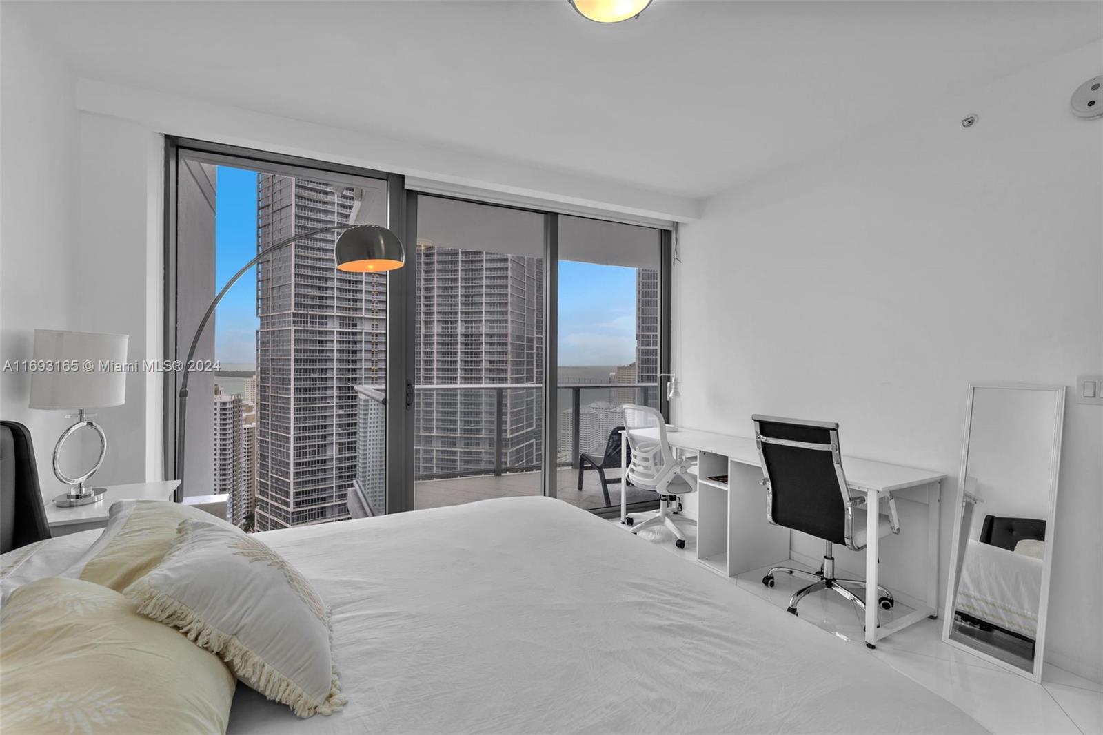 Downtown Miami Miami, FL 33131 - Photo 18 of 25 a bedroom with a bed a chair and a large window