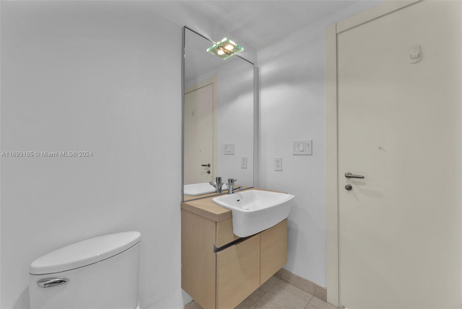 Downtown Miami Miami, FL 33131 - Photo 19 of 25 a bathroom with a sink a toilet and shower