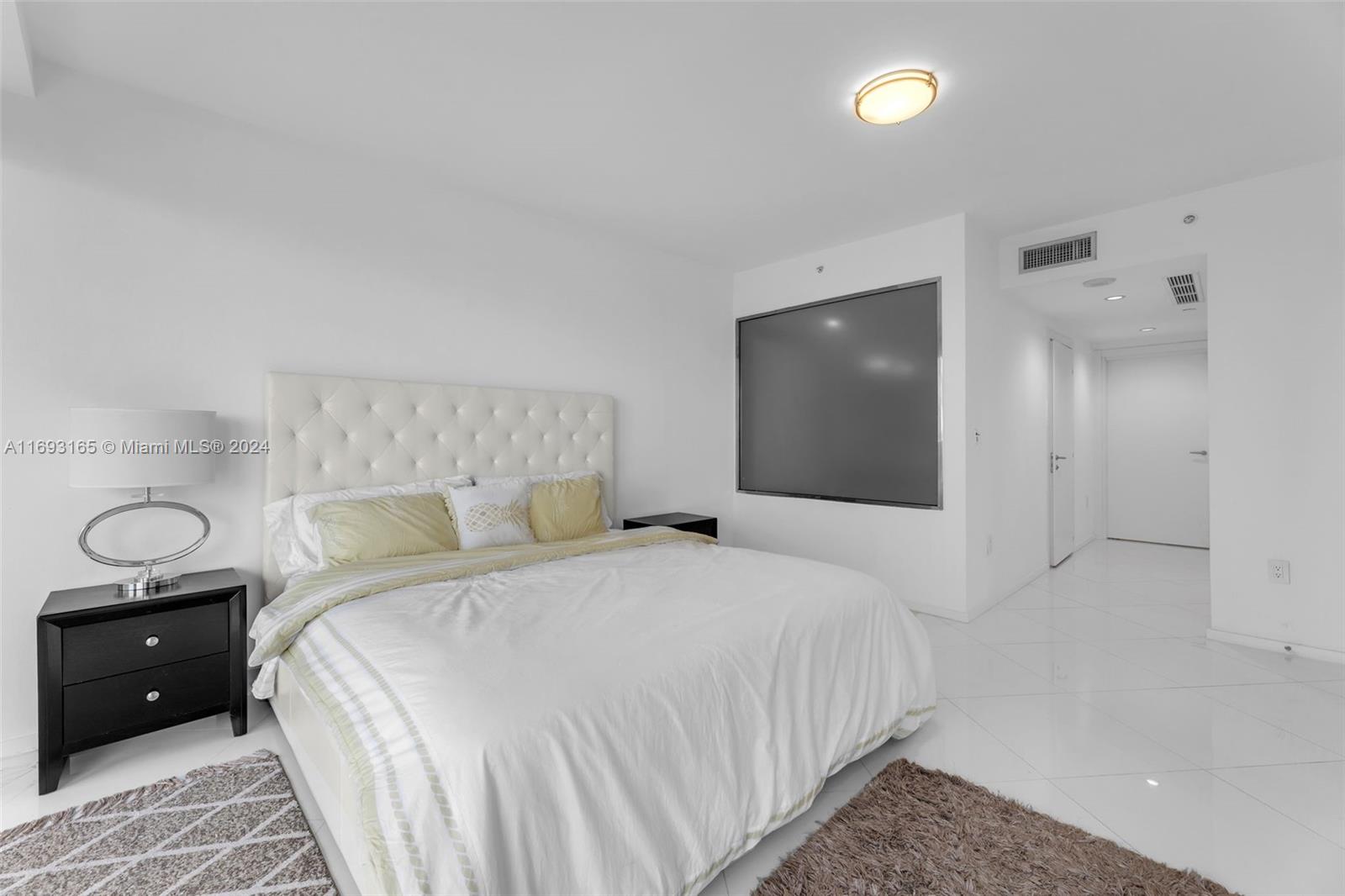 Downtown Miami Miami, FL 33131 - Photo 10 of 25 a bedroom with a bed and a flat screen tv