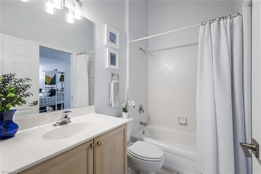 5360 Andover Drive, Unit 202 Naples, FL 34110 - Photo 18 of 25 a bathroom with a sink a toilet and shower