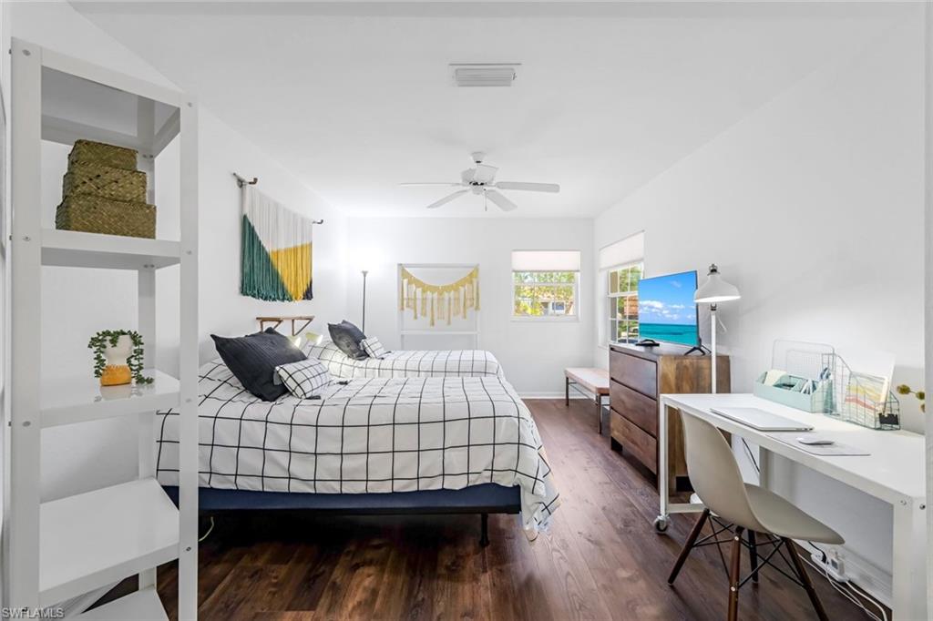 5360 Andover Drive, Unit 202 Naples, FL 34110 - Photo 19 of 25 a bedroom with a bed a table and painting on the wall