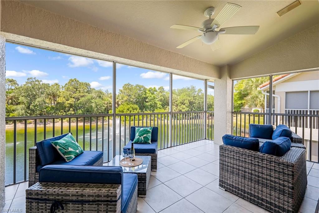 5360 Andover Drive, Unit 202 Naples, FL 34110 - Photo 2 of 25 a living room with furniture and a floor to ceiling window