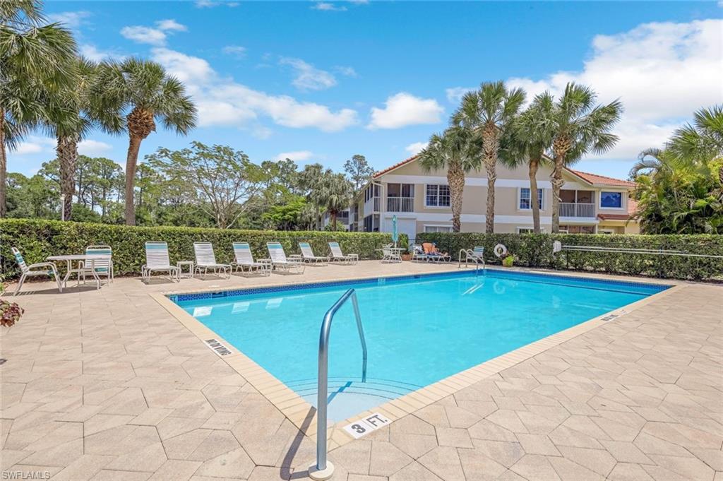 5360 Andover Drive, Unit 202 Naples, FL 34110 - Photo 25 of 25 a view of a swimming pool with a lounge chairs