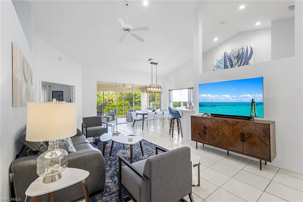 5360 Andover Drive, Unit 202 Naples, FL 34110 - Photo 5 of 25 a living room with furniture and a flat screen tv