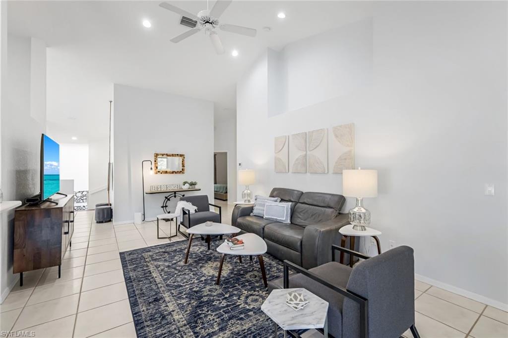 5360 Andover Drive, Unit 202 Naples, FL 34110 - Photo 6 of 25 a living room with furniture and a flat screen tv