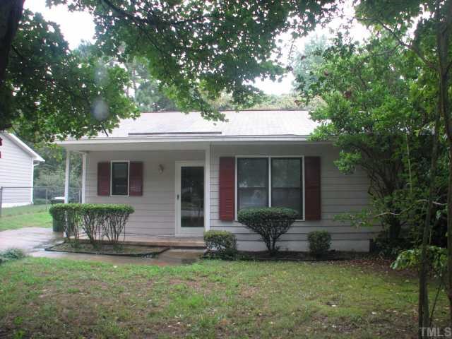 3706 Pine Knoll Drive Raleigh, NC 27604 - Photo 2 of 3 a front view of a house with a garden and porch