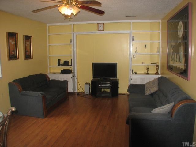 3706 Pine Knoll Drive Raleigh, NC 27604 - Photo 3 of 3 a living room with furniture and a flat screen tv