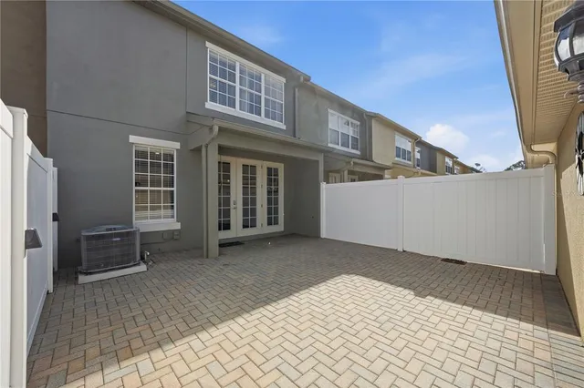 a view of a house with backyard and deck